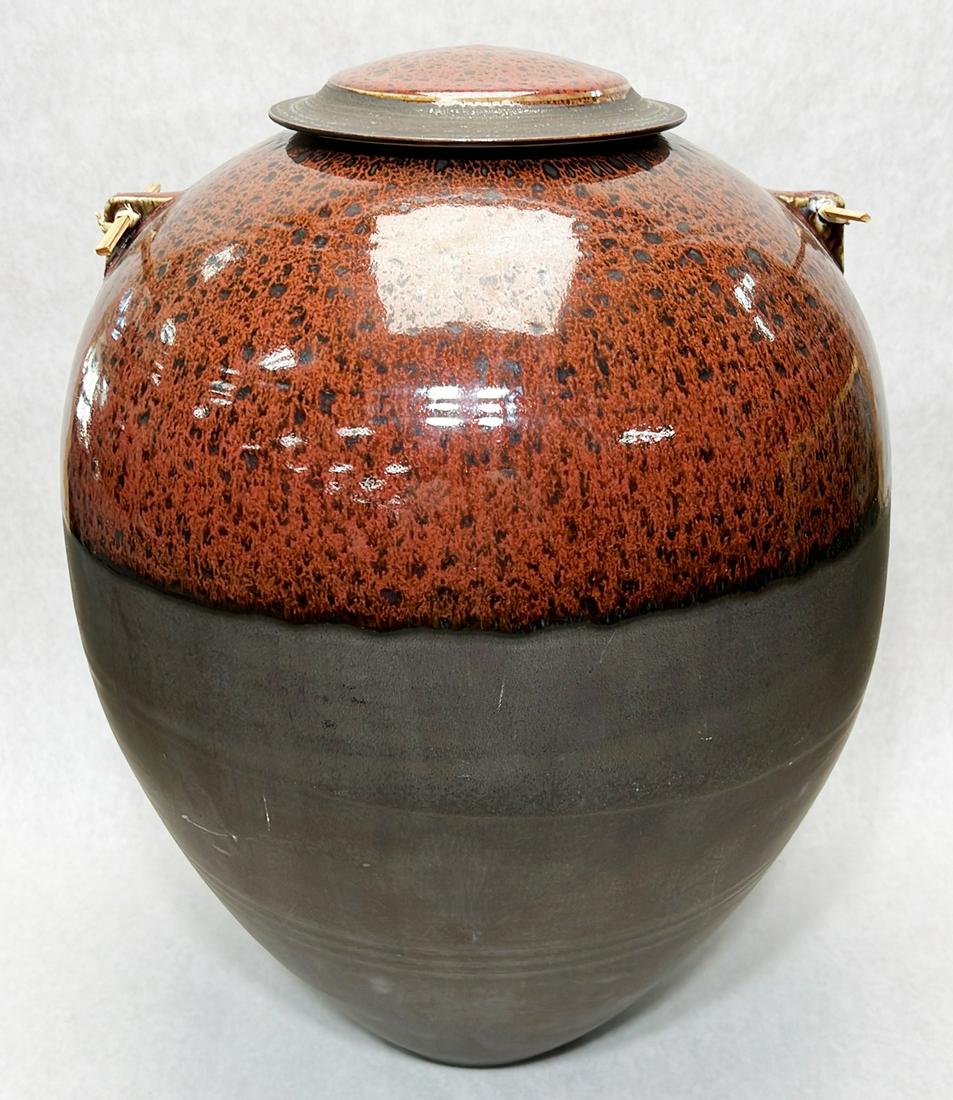 Stephen Merritt art pottery covered vessel: Signature to underside. Measures 19" in height.