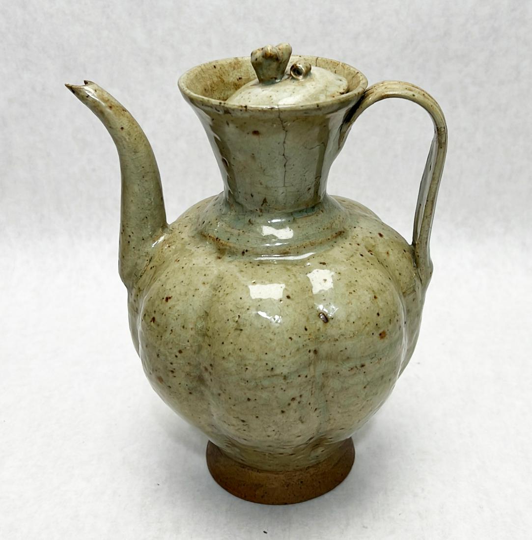 Chinese celadon porcelain wine pot: Measures " in height. Chips to spout and hairlines to top rim.