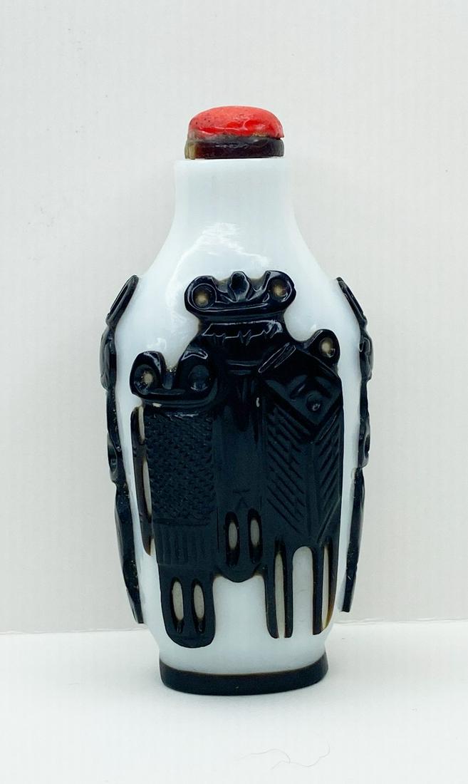 Chinese Carved Peking Glass Snuff Bottle: 3" tall, 1.5" at widest.