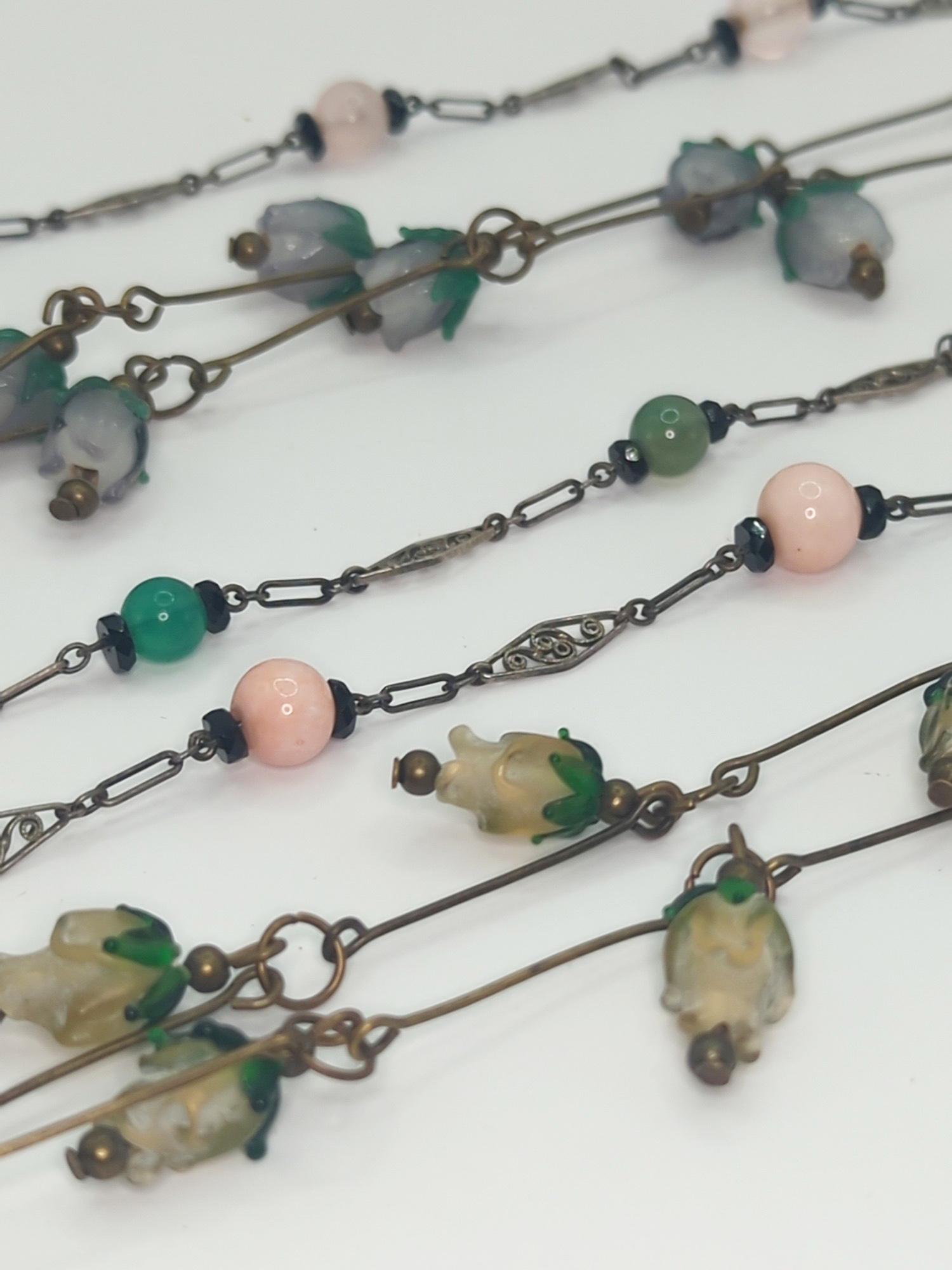 ART DECO FASHION JEWELRY; Filigree/Wirework Glass Bead Jewelry: Two necklaces with fruit beads measuring 19 1/2" and 20", three bracelets measuring 7 1/2" - 7 3/4". Minor imperfections.
