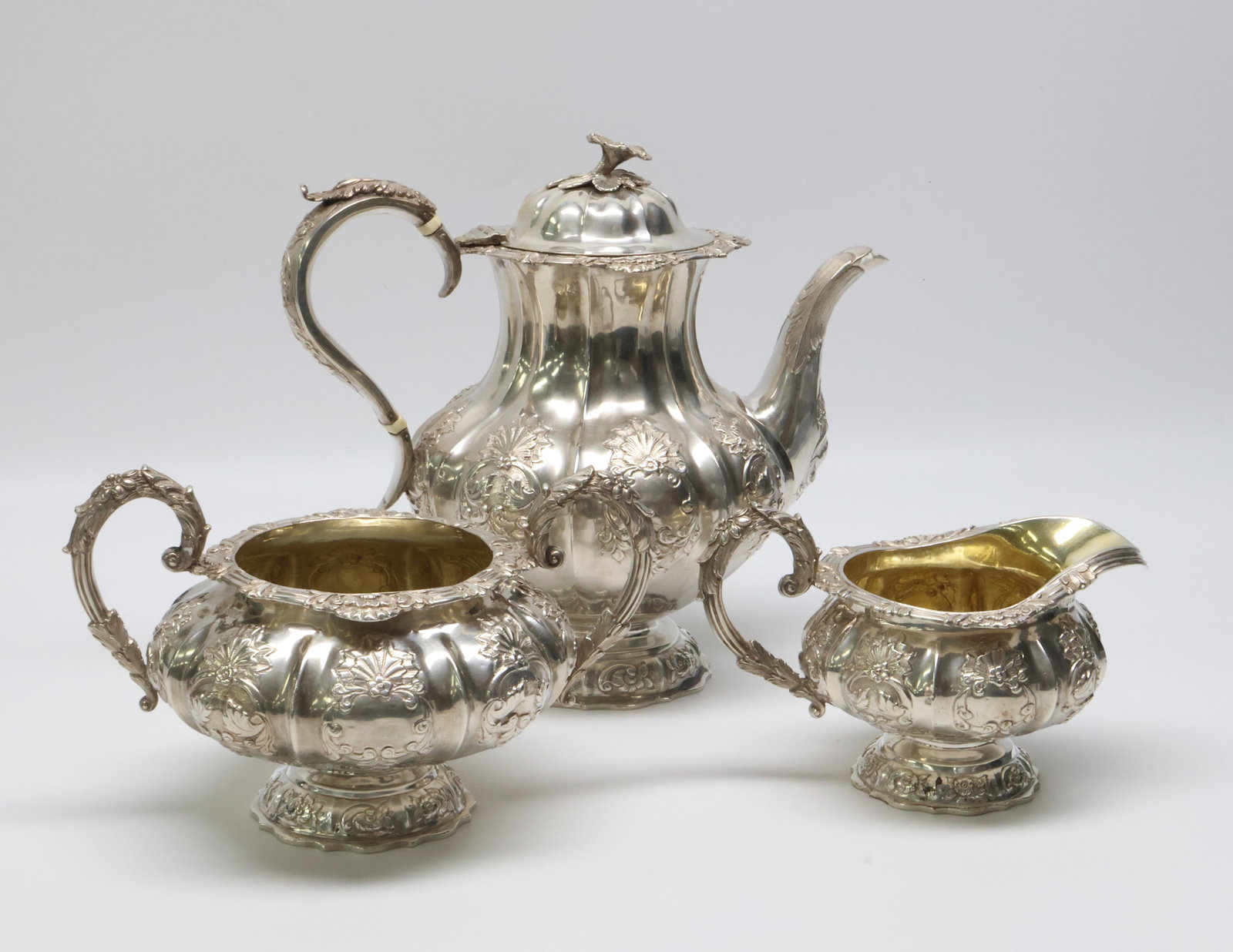 3 Piece English Hallmarked Sterling Silver Tea Set 57.1 ozt.: Tea Pot - 8 1/2" X 10 1/2" Approx., 30.8 ozt., Sugar - 5 1/4" X 8 1/2" Approx. 16.1 ozt., Creamer 5 1/4" X 8 1/2" Approx. 10.2 ozt. , Repair to Spout