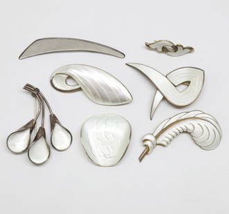 SCANDINAVIAN; Seven Modernist White Enamel Silver Brooches: 20th Century. Makers Include Albert Scharning, J. Tostrup, Volmer Bahner. Sizes From 1 3/8" To 2 3/4". Total Weight 59 Grams.