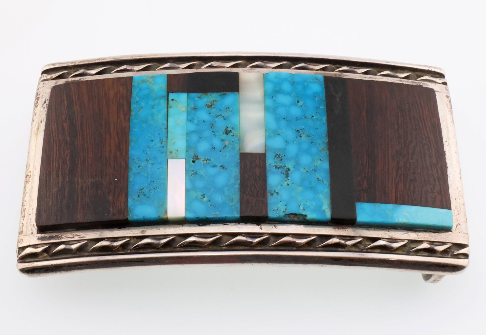 D M Silver Native American Turquoise, Mother of Pearl & Wood Inlaid Belt Buckle 4.2 ozt: Metal Type/Purity: Silver Weight: 4.2 ozt Dimensions: 4" X 2.25" Approximately Hallmarked With Symbol
