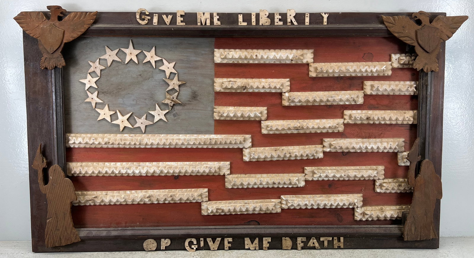 Outsider art carved "Give me Liberty or Give me Death" patriotic wall plaque: Late 19th or early 20th century. Losses. Appx. 24 inches by 43 1/2 inches overall.