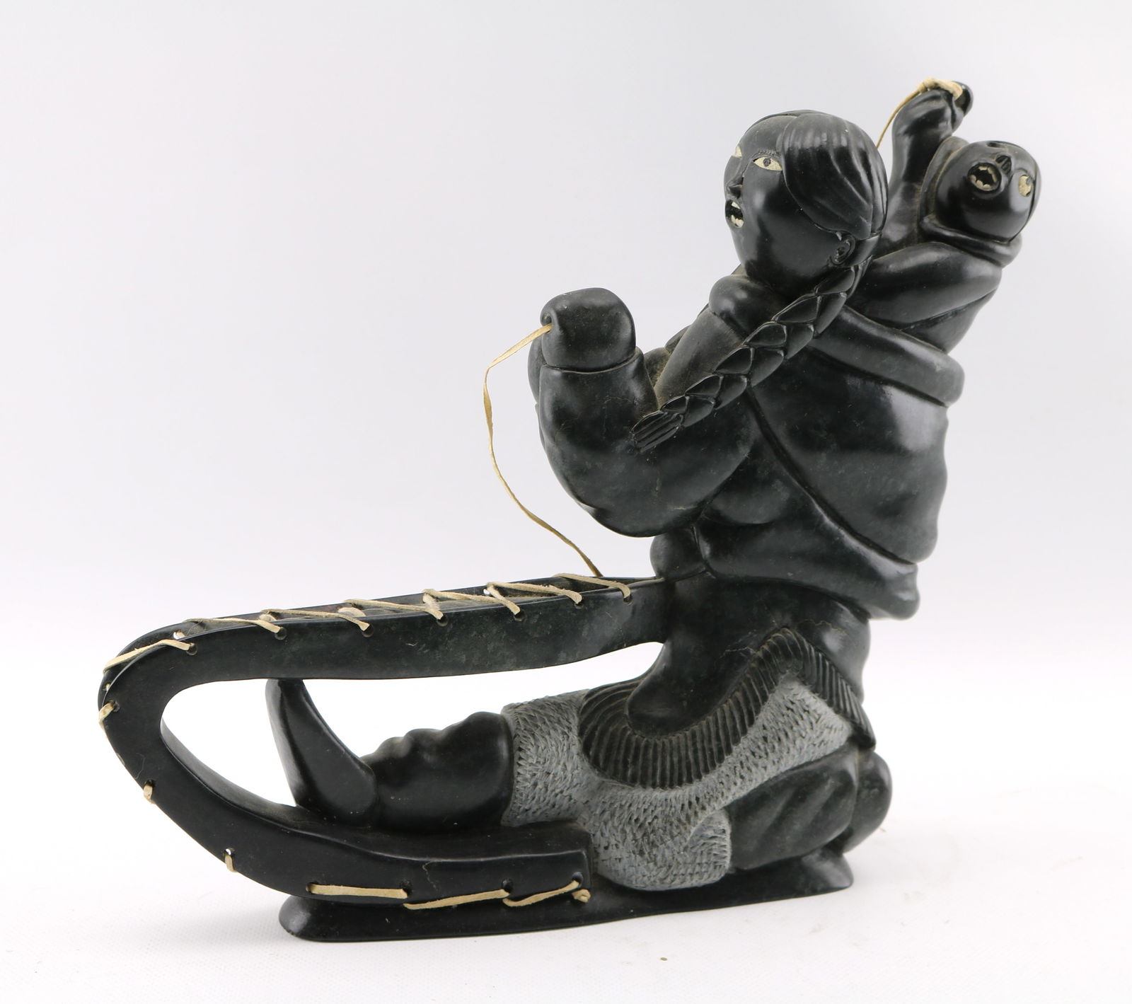 Noah Echalook Mother and Child on Sled Inuit Art Soapstone and Antler Sculpture: Height appx. 12 inches, weight appx. 11 pounds. Child missing one eye and other eyes are worn.