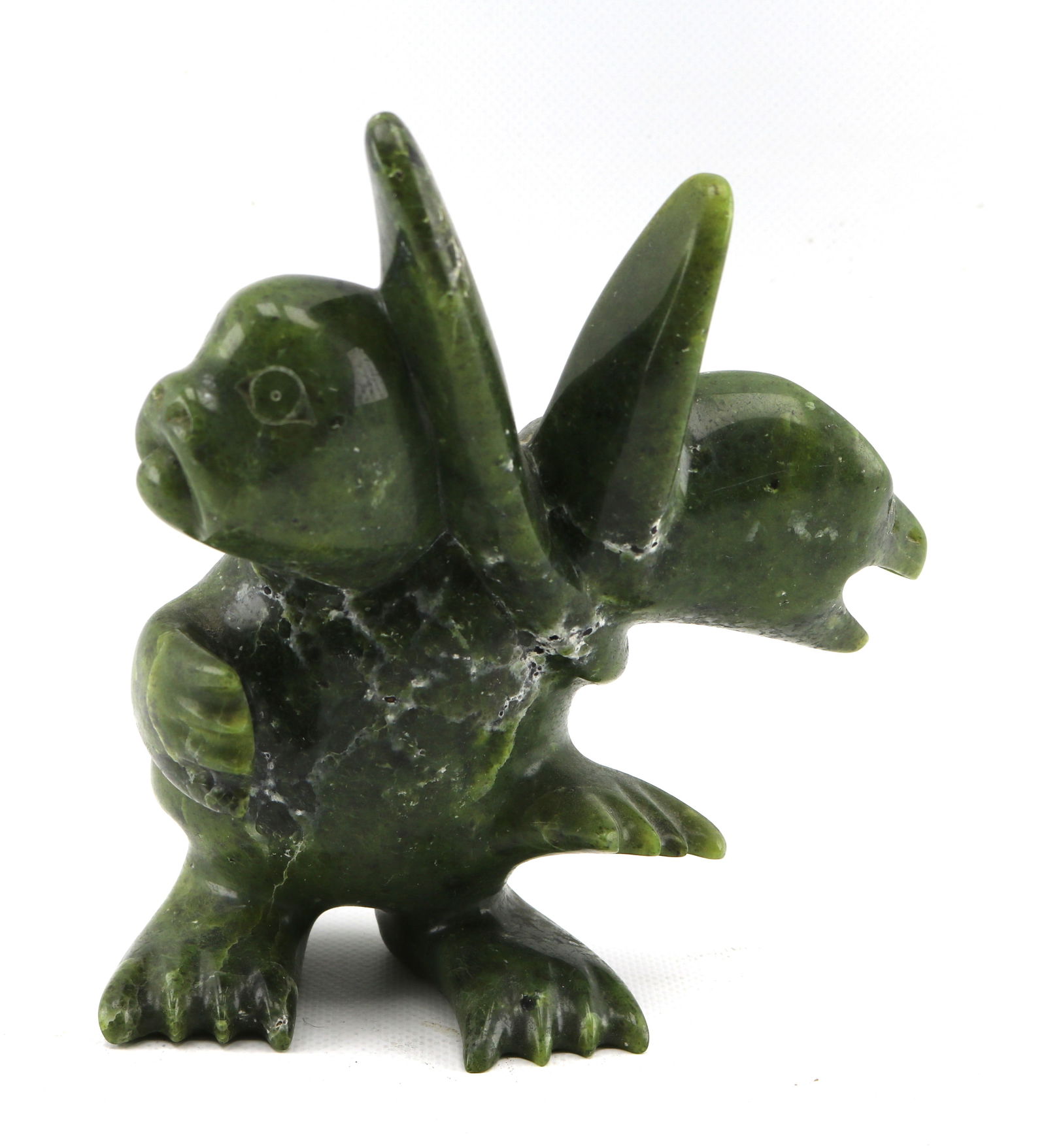 Tukiki Manumie Seal Transformation Inuit Art Serpentine Stone Sculpture: Height appx. 7 inches, weight appx. 4 pounds. Provenance: Houston North Gallery, 1994 (accompanied by original receipt and additional documentation).