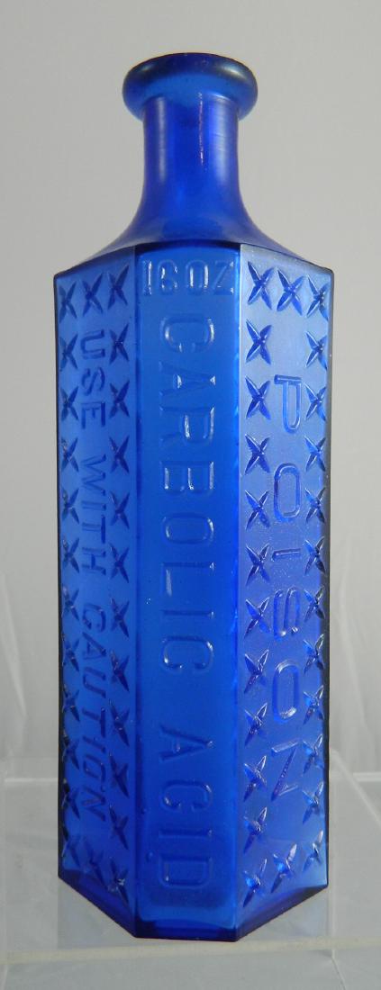 Poison bottle- irregular hexagon: Poison- irregular hexagon, front 3 panels embossed 'Poison - Carbolic Acid - use with Caution' back and 2 side panels plain (Kuhn KI4). 8 1/2''