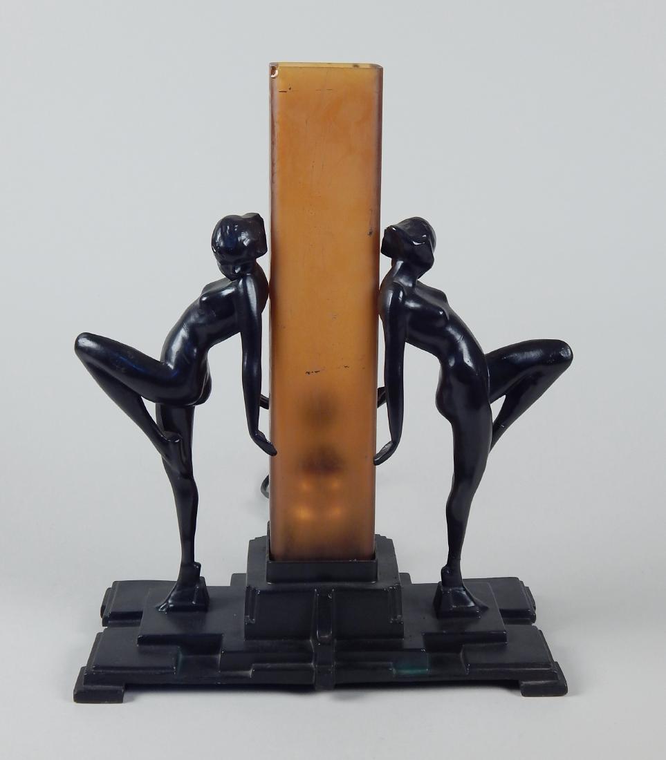 Frankart lamp: Frankart Inc.- Lamp No. 222- 2 nude figures embrace glass column, black ebony finish, glass column is amber with smooth satin finish, one figure has has separation at the ankle, other figure has repai