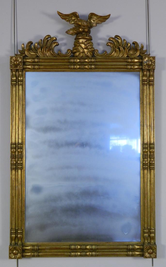 Federal style gilt wood mirror: Federal style gilt wood mirror, with rosettes in the corners, surmounted by an eagle, flanked by cartouches, good condition. 54 x 32'', 37 1/2 x 25 1/2'' (mirror)