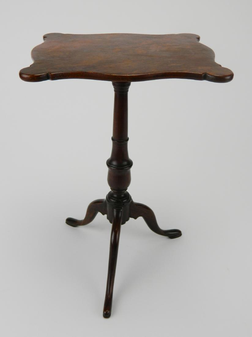 Miniature tilt top table: Miniature tilt top table with a burl sepentine cut-out top, supported by a turned column ending in three cabriol legs, note: repair to top and catch latch ding to underside. top- 8 x 6 3/4'', 12''h