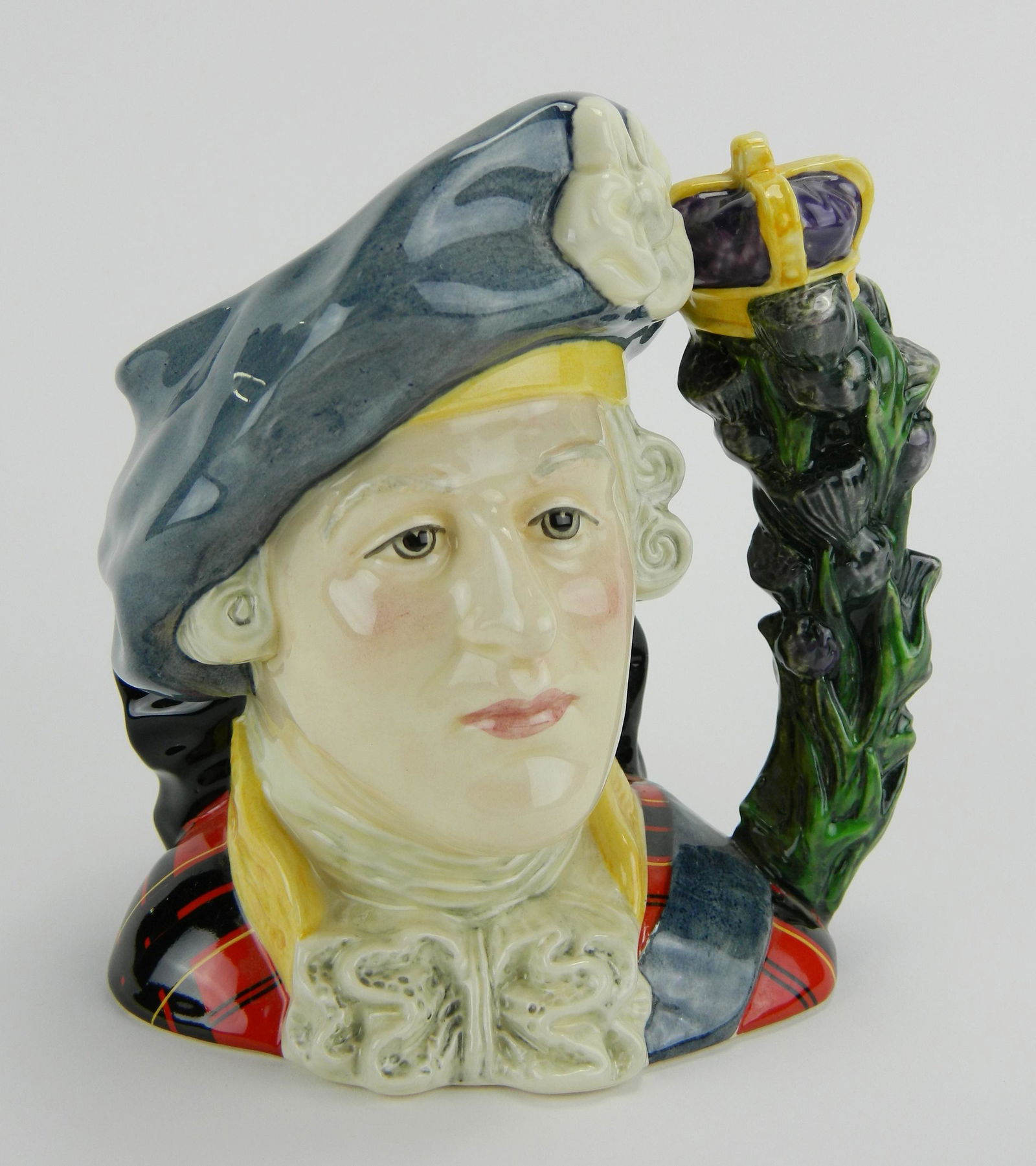Royal Doulton Toby Jug: Royal Doulton Toby Jug of Prince Charles Stuart, depicted wearing a Jacobite blue cap embellished with a white cockade and a red tartan suit, issuing from its side a crown topped thistle form handle,