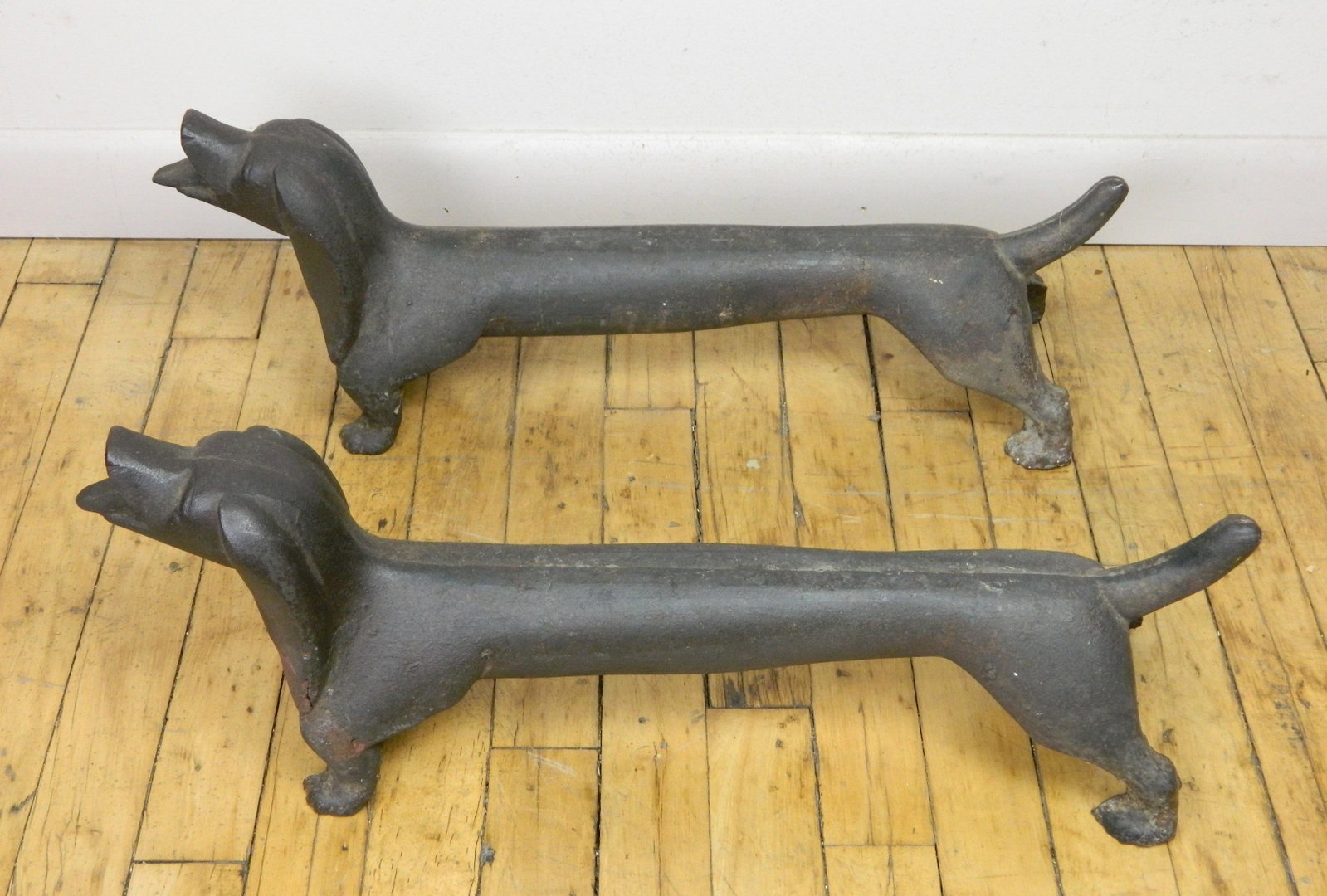 Pair of Figural Dachshund andirons: Pair of Figural Dachshund andirons. 8 x 22 1/2 x 6'' Total weight 40 lbs.