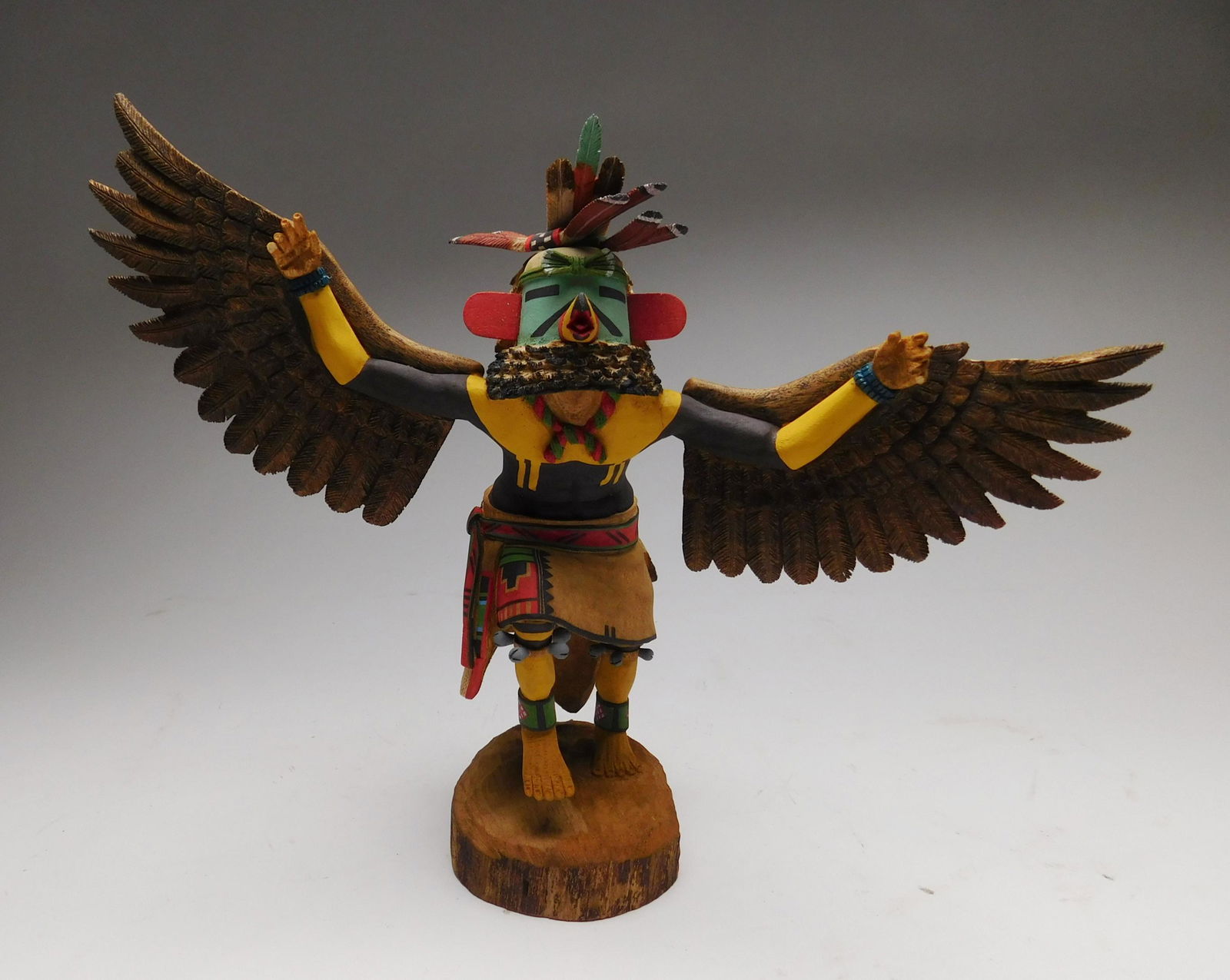 Silas Roy Kawahu kachina: Silas Roy Hopi Kawahu kachina- carved and painted wood, signed 'Silas Roy' bottom, some loss to fingers and feather, arm repaired at shoulder. 11 1/2"h