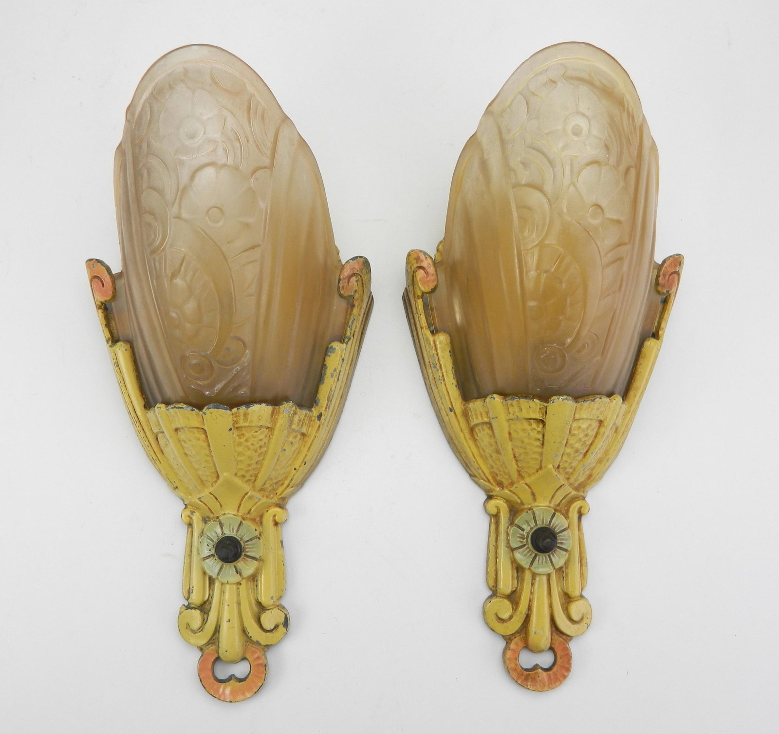 Pair of cast iron Art Deco wall sconces: Pair of Art Deco wall Sconces, painted cast metal with frosted pink glass shades, wear from use. 12 x 5 4''