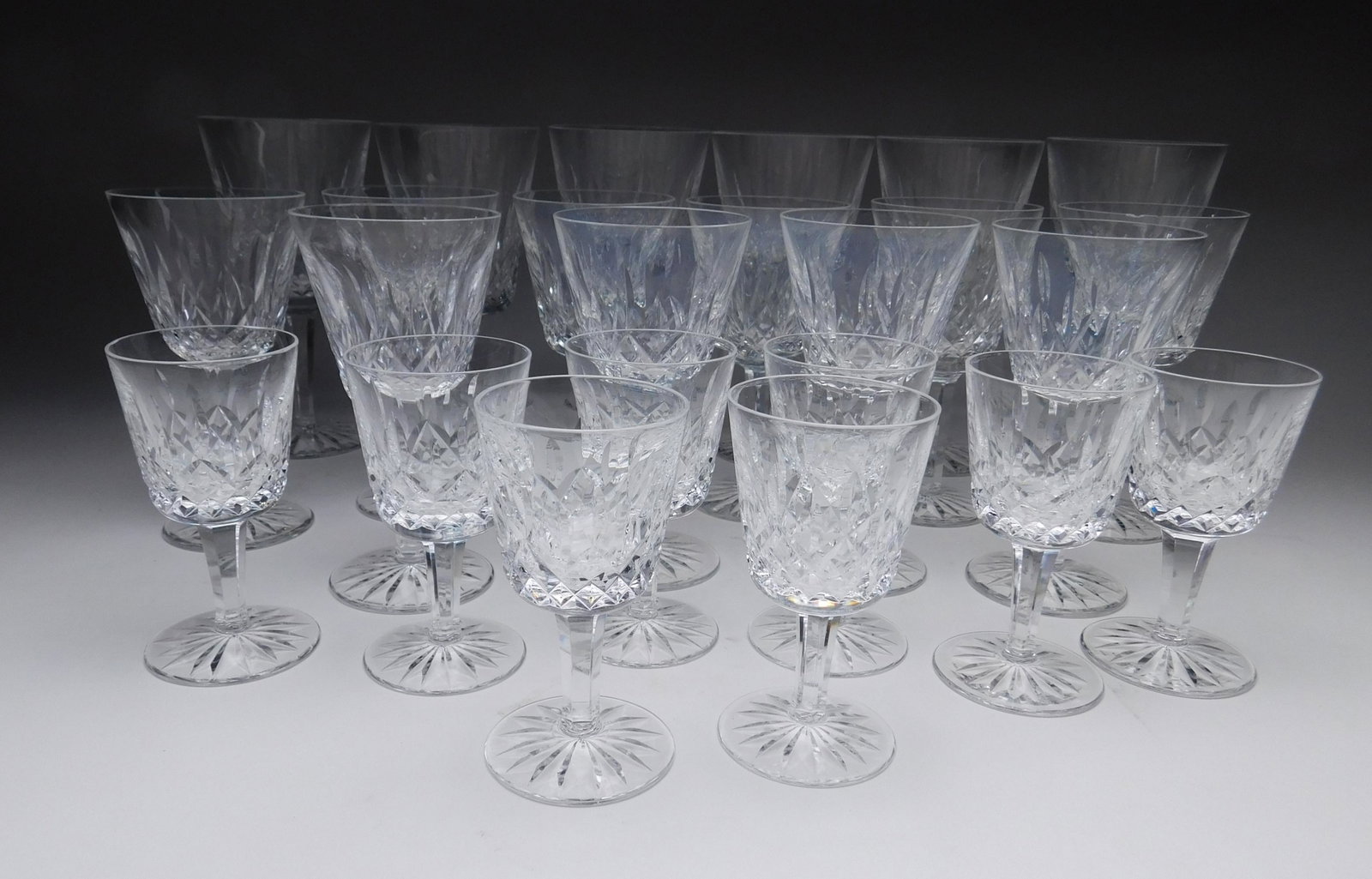 24 Waterford: 24 Waterford crystal stemware, ''Lismore'' pattern- 6 wine glasses- 6 7/8''h; 10 wine glasses- 5 3/4'' and 8 liquor glasses- 4 1/4''h. Each marked on bottom, 1 larger wine glass has chips at base, 1 s