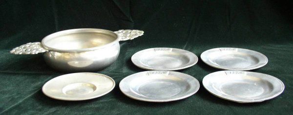 Lot of Pewter: Lot of pewter items including, 8 plates, pair of candlesticks, bowl, wine coaster, porringer and a wine taster, generally good condition.