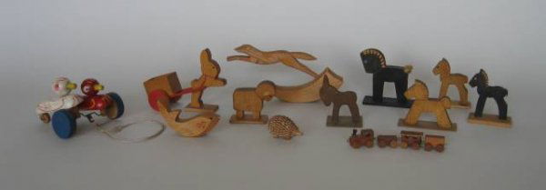 12 German wood animal figures: 11 Early 20th c. German small wood animal figures including four horses on wooden base, a lamb and donkey on wooden base, fish, turned and carved porcupine, pair of ducks on wheels, rabbit hitched to