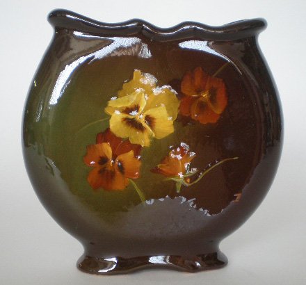 Weller Louwelsa Pillow vase: Weller Louwelsa Pillow vase, decorated with spray of pansies, half-circle mark, artist signed- John Butterworth. 7''h