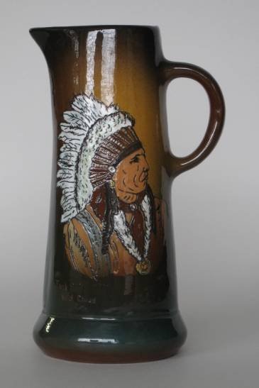 Rose Pottery pitcher: Rose Pottery pitcher, decorated with portrait of Indian ''Jack Red Cloud'', marked and artist signed 'Twain' on bottom. 11 1/4''