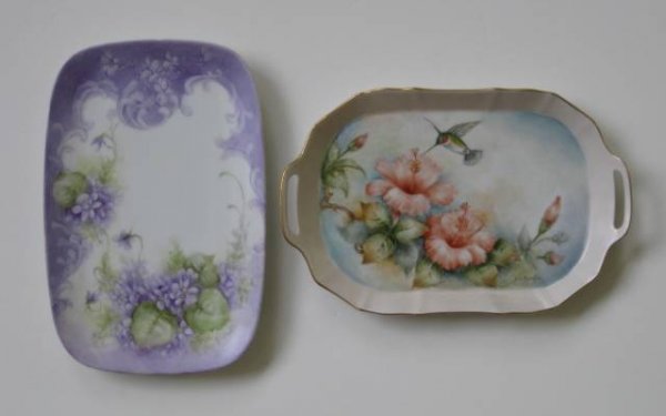 H. Litkovitz two hand-painted porcelain trays: Two hand-painted porcelain trays by Helen Litkovitz- 1 Hummingbird on Hibiscus, double handled, applied gold edge; 1 Lavender Violets, rectangular form and round edges; both signed, very good conditio