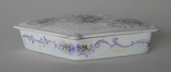 H. Litkovitz hand-painted porcelain box: Hand-painted porcelain fan shaped box with lid by Helen Litkovitz, decorated with lavender, daisies and scroll work, opalescent sheen on various areas, signed lower right on lid, very good condition. 