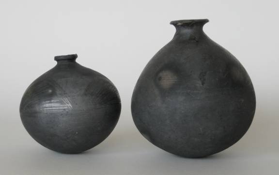 4 Mexican black ware items: 4 Mexican black ware ceramic items- 1 vase, reduction-fired, Dona Rosa, 1970's-80's, 4 5/16''h; 1 pitcher, reduction-fired, 1970's-80's, 6 1/4''h; 1 bottle, unglazed, 7 1/4''h; and 1 round bottom jar,