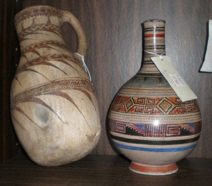 2 Mexican ceramic items: 2 Mexican ceramic items- 1 tall pitcher and 1 water bottle, typical wear and tear, otherwise good condition. Pitcher 11''h, Bottle 10 5/8''h
