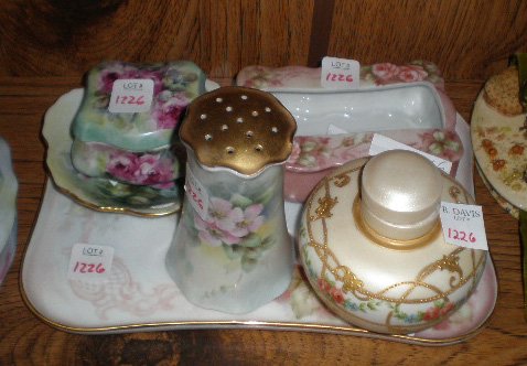 6 hand-painted porcelain dresser items: 6 hand-painted porcelain dresser items- 4 by Helen Litkovitz: a tissue dispenser, a hat pin holder, a tray and a round container with cap; 1 by Mary Patusky: a small plate with scalloped edge; and 1 s