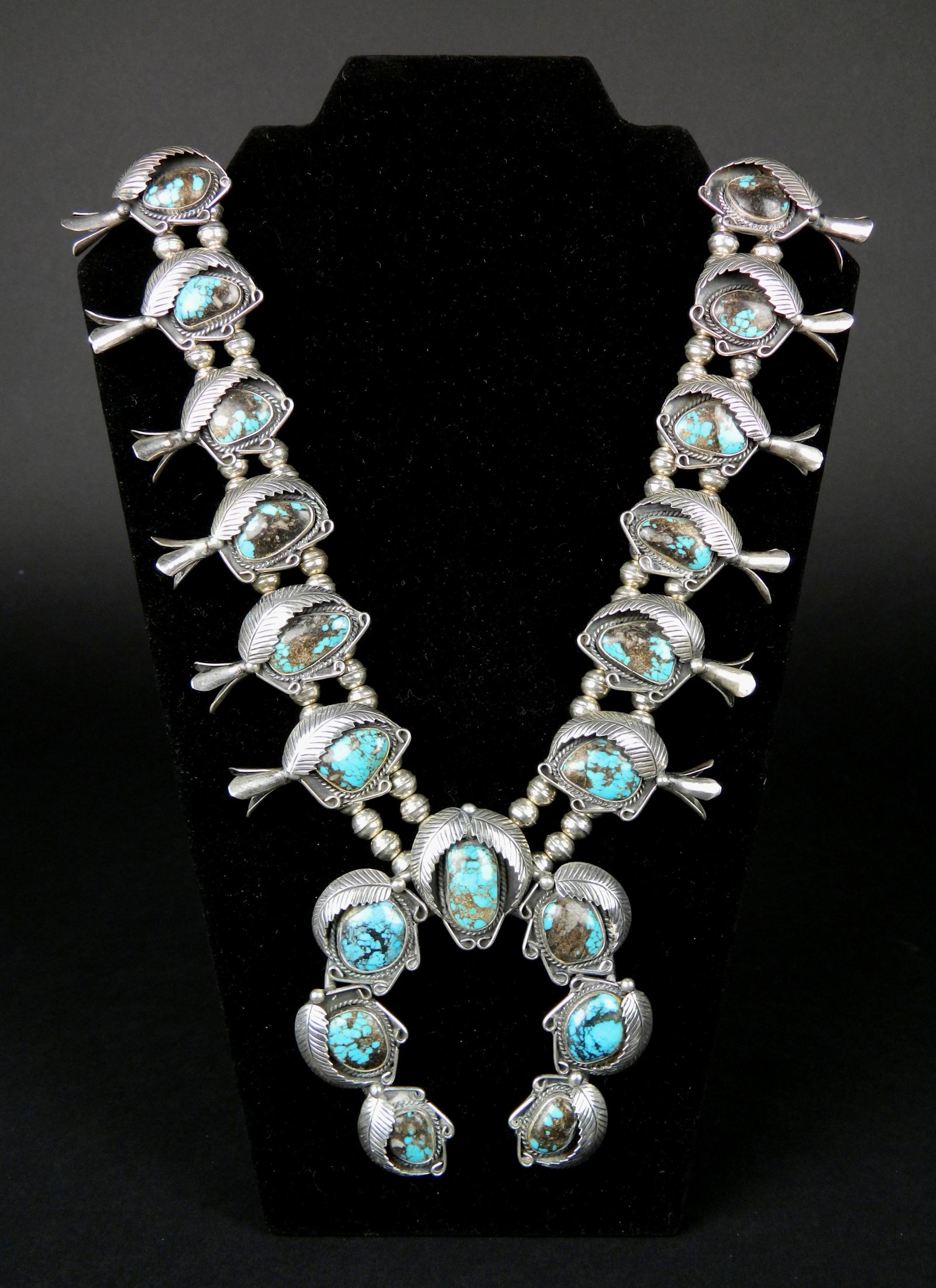 Richard Begay squash blossom necklace: Richard Begay squash blossom necklace with 6 blossoms on each side, 19 turquoise stones, marked 'R.B'.