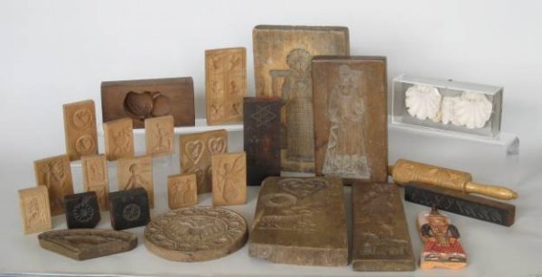20 wooden cookie molds, 20th c.: 20+ 20th c. Wooden cookie molds from various countries- 15 German, 3 English and 2 Belgian, together with cake mold and half of a 2-part Japanese cookie mold, an August Frederick Biehle Sr. plaster mo