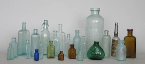 20 Antique glass bottles: 20 Antique glass bottles- various products and makers, one with paper label for 'Florida Water', some nicks, scratchers and discoloration. various sizes