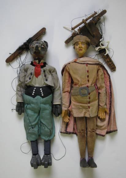 2 Marionettes: 2 20th c. Marionettes- 1 Man with cape, 1 Dog, some wear, scratches, nicks and cracks, tangled strings, fair condition. 23''l, 21''l