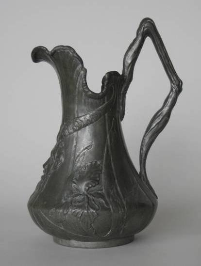 Kayserzin pewter pitcher: Kayserzin pewter pitcher- decorated in relief with a satyr mask and iris, branch handle. 13''h