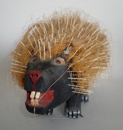 Ronald Rodriguez wood sculpture: Ronald Rodriguez (American 20th c.)- Porcupine-painted wood sculpture, 1992, with applied quills, straw hair and glass eyes, signed and dated on bottom, very good condition. 9''h, 16''l