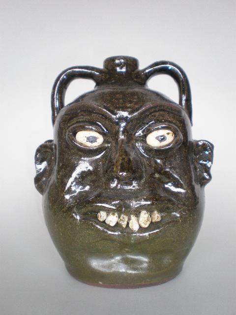 Lanier Meaders ceramic sculpture: Lanier Meaders (American 1917-1998)- Double Face Jug- ceramic sculpture, ca. 1970's, with rock teeth, signed Lanier Meaders (in script) on bottom. 9 3/4''h