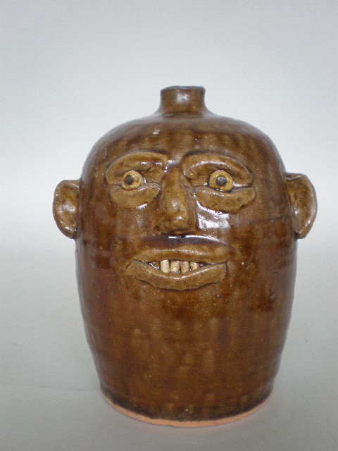 Reggie Meaders ceramic sculpture: Reggie Meaders (American 20th c.)- Face Jug- ceramic sculpture. 7 3/4''