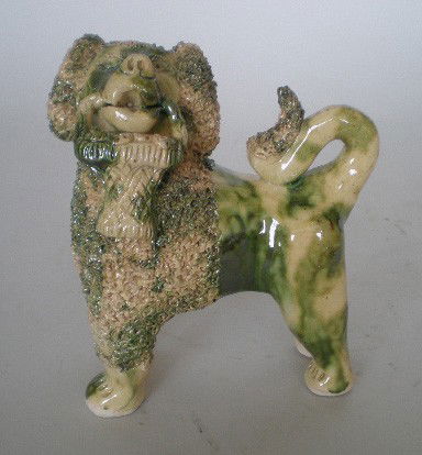 Billy Ray Hussey ceramic dog: Billy Ray Hussey (American 1955- )- Bennington Spaniel with Basket- ceramic sculpture, green and cream glaze, initialed B.H., very good condition. 6''h