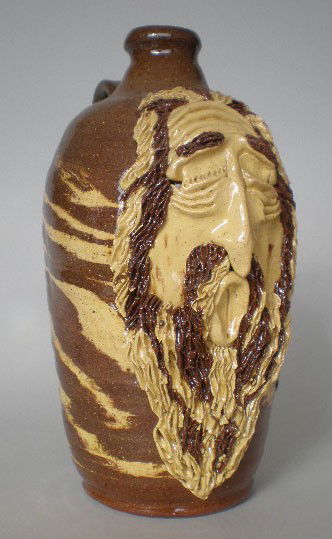 Billy Ray Hussey face jug: Billy Ray Hussey (American 1955- ) face jug, dark and light brown swirl, ca. 1982-3, signed Owens/BH -bottom, very good condition. 12''h