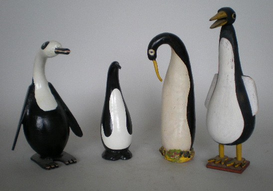4 Folk Art penguins: 4 Folk Art penguins- Ronald Cooper- painted gourd and wood, 1999, signed; Carol Skok- painted gourd; a unkonwn painted wood ;and a unknown painted gourd. 9'' to 13 1/2''