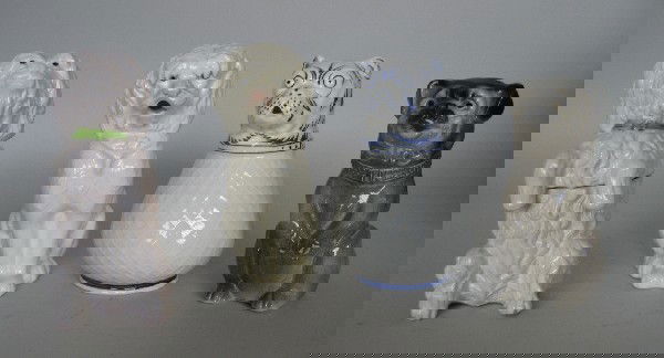 4 Figural Dog porcelain items: 4 Figural Dog porcelain items- 1 container with lid of a white hair dog, marked Jean Roger Paris; 3 pitchers- 1 with crack. various sizes