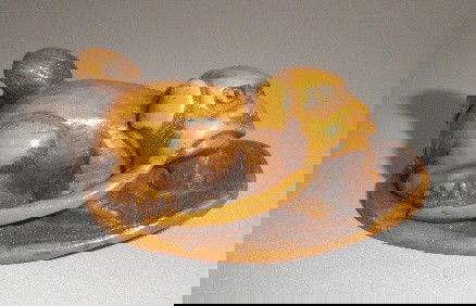 Carved netsuke: Carved ivory netsuke- Dog Lying, Chewing Sandal Strap- signed on bottom, good condition. 2''l