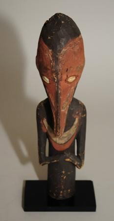 Oceanic figure and wood bowl: Kokomo Figure- Yamok Tribe- wood, shells and pigment. 13 x 3 x 2 1/2'' Wooden Food Bowl- Numingwa Village, Sepik Region. 7 x 3''