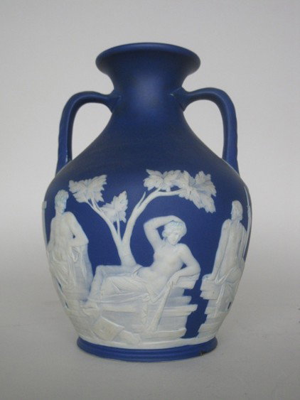 Wedgwood jasperware 'Portland' vase: Wedgwood blue Jasperware 'Portalnd' vase with white classical figures on a deep blue ground, marked Wedgwood/ England, one small chip at base. 8''h