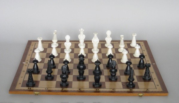 Italian carved marble chess set: 20th c. Italian carved marble chess set with carrying case and a wooden playing board, very good condition.