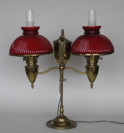 Late 19th c. Brass double student lamp: late 19th c. brass double student lamp with removeable kerosene resevoir and red cased glass shades, electrified. 22 1/2''