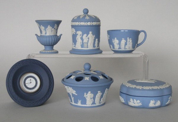 6 Wedgwood jasperware items: 6 Wedgwood jasperware items, all are white classical figures on a blue ground, includes a flower arranger, 2 covered boxes, cigarette cup and a clock, all marked, very good condition, various sizes.