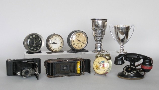 Lot of vintage household items: Vintage household items including a Walt Disney porductions alarm clock, camera a Western electric cradle phone, 2 silver plate trophies, other alarm clocks, all as is