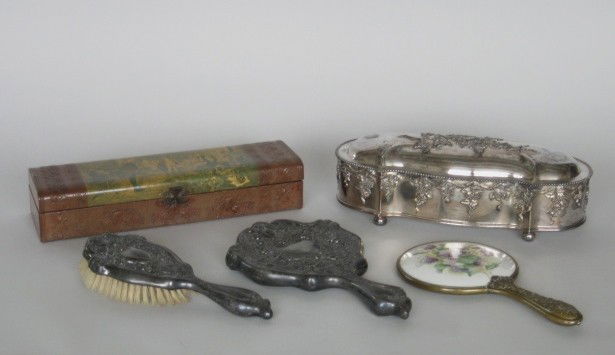 Lot of silver plate ladies accoutrements: 2 silver plate art nouveau hand mirrors (1 with a porcelain inset medallion) and a brush, together with 2 glove boxes (1 silver plate and 1 papier mache). Heavy tarnishing on hand mirrors and some on