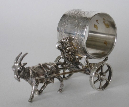 Victorian figural silver plate napkin ring: Victorian figural silver plate napkin ring, Billy Goat and Cart, marked 'Roger Bros, some scratches and tarnishing from use otherwise very good condition. 3"h