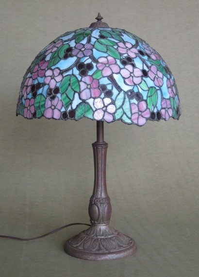 Contemporary leaded glass table lamp: Contemporary leaded glass table lamp- pink flowers with green leaves against a blue background. 24''h, shade- 8 1/2''h, 16 1/2''dia